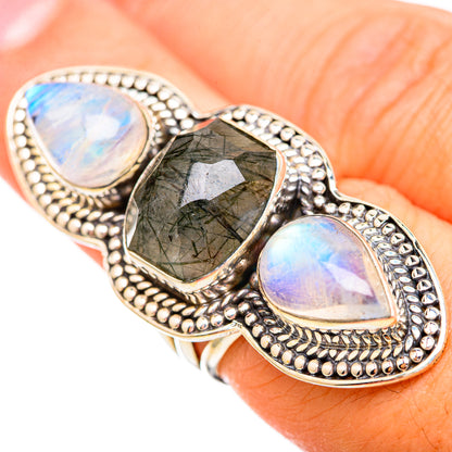 Sterling silver three-stone ring with dark green center and two blue-white opalescent stones