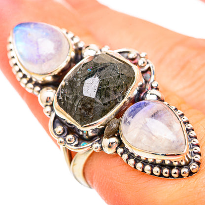 Sterling silver ring with oval iridescent moonstone-like stones and dark center gem