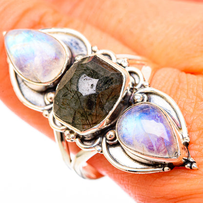 Sterling silver gemstone ring with faceted dark green center and two oval opalescent stones