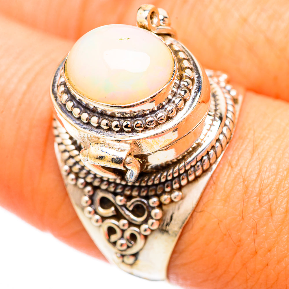 Sterling silver ring with oval white opal cabochon and detailed engraved band