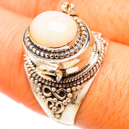 Sterling silver ring with oval white opal cabochon and detailed engraved band