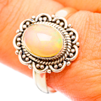 Sterling silver opal ring close-up: round opal cabochon with ornate beadwork halo
