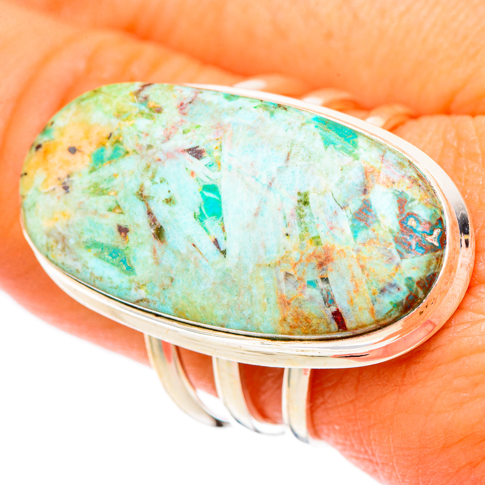 Large oval turquoise gemstone ring close-up on silver bezel and prongs