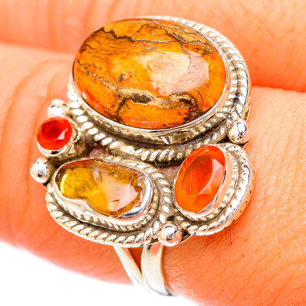 Orange oval cabochon ring with red and yellow stones in braided sterling silver frames