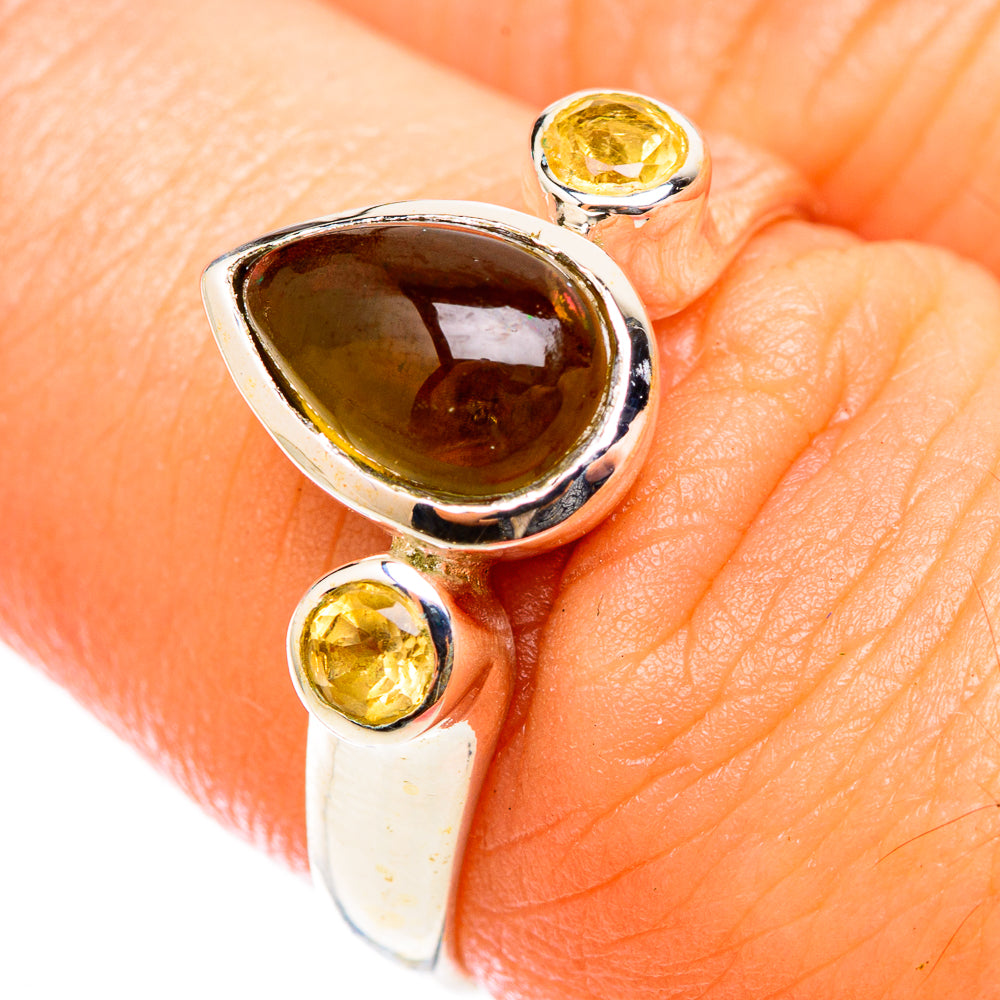 Sterling silver ring with dark amber teardrop stone and two round citrine accents