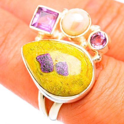 Sterling silver ring close-up: yellow teardrop cabochon, purple square, round stones, pearl