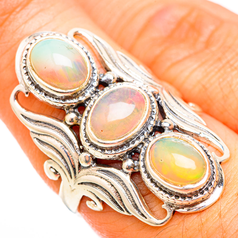 Sterling silver opal ring with three oval rainbow stones, ornate leaf setting