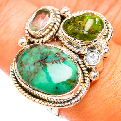 Oval turquoise and green gemstone ring with round clear accents, ornate silver setting