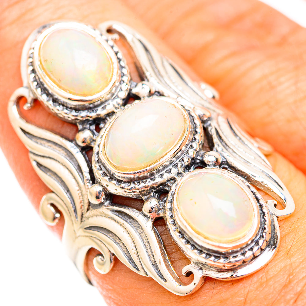 Triple oval opal cabochon ring in 925 sterling silver with gold-tone bezels on finger