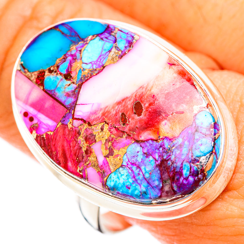 Oval gemstone cabochon ring with blue, pink, and gold veining, silver bezel