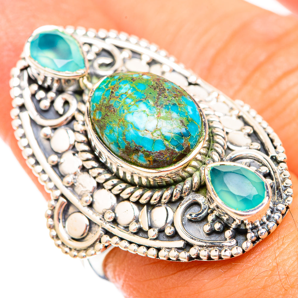 Ornate sterling silver ring with large turquoise oval stone and two smaller bezel-set accents