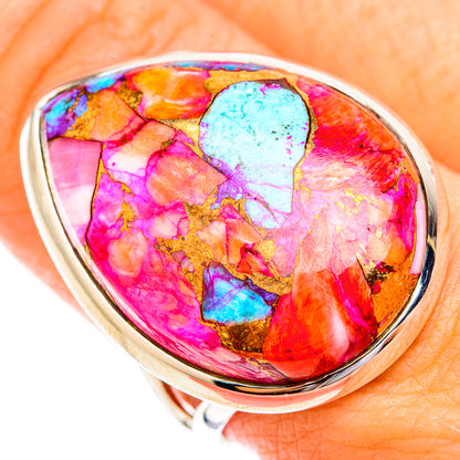 Sterling silver ring showing vivid pink, orange, blue oval opal cabochon
