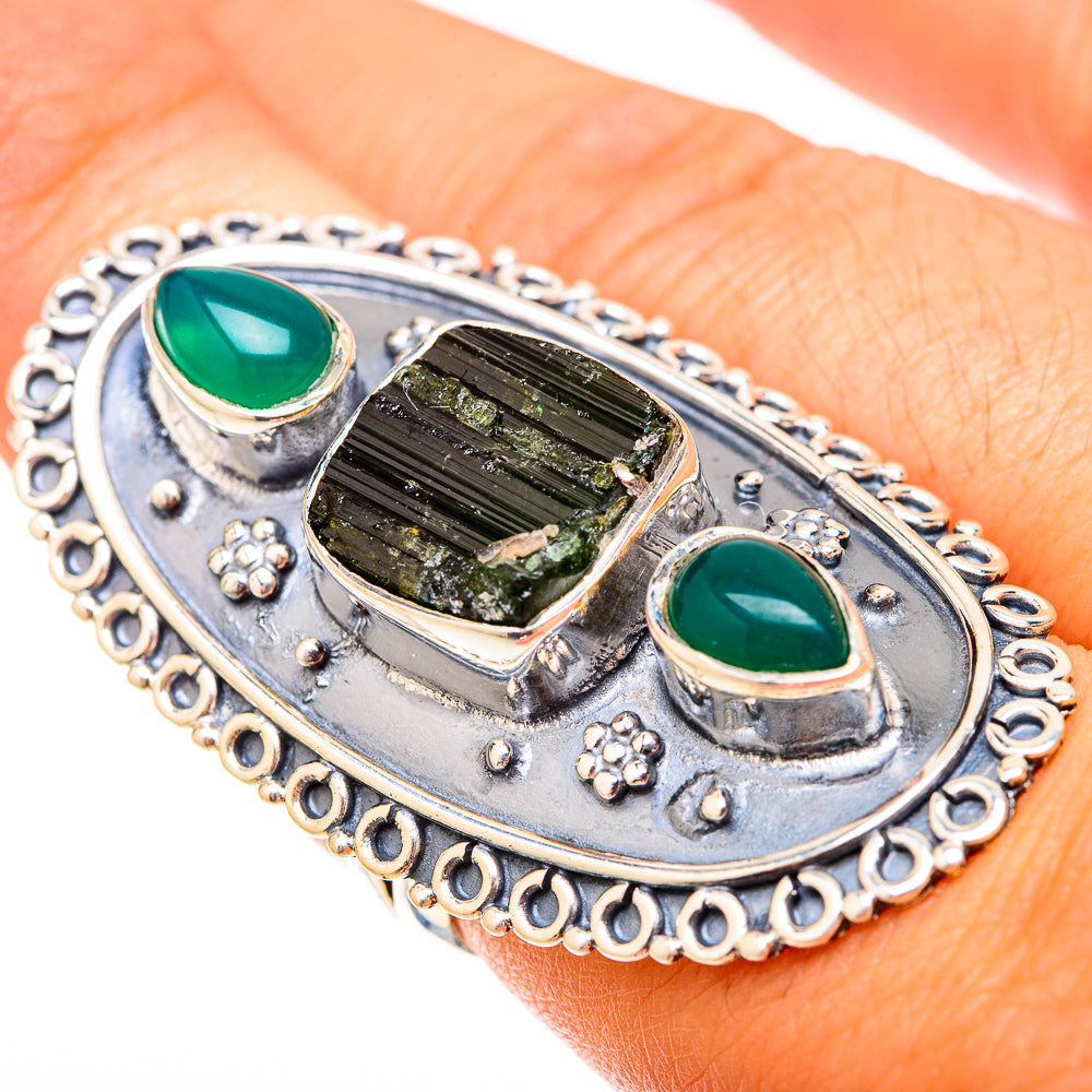 Sterling silver ring with textured green stone centerpiece and two oval green cabochons