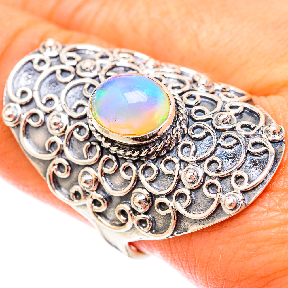 Sterling silver ornate filigree ring with oval opal cabochon, rainbow iridescent center