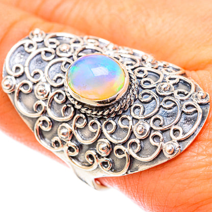 Sterling silver ornate filigree ring with oval opal cabochon, rainbow iridescent center