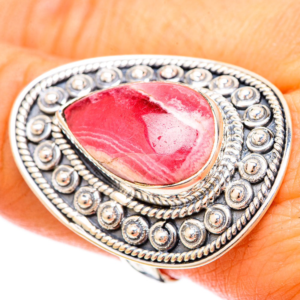 Rhodochrosite teardrop sterling silver ring on finger, ornate bead bezel