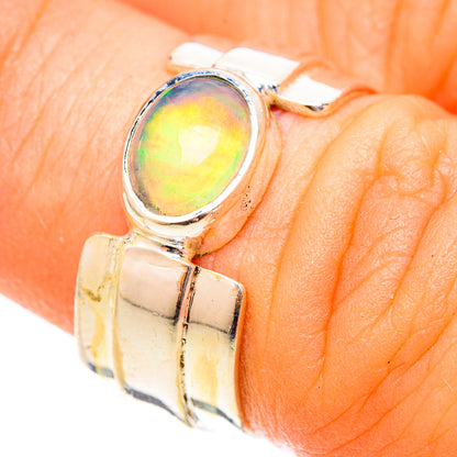 Sterling silver opal ring side view, oval bezel with rainbow light