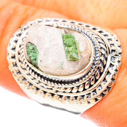 Detail view of silver oval ring, green tourmaline quartz centerpiece in rope bezel