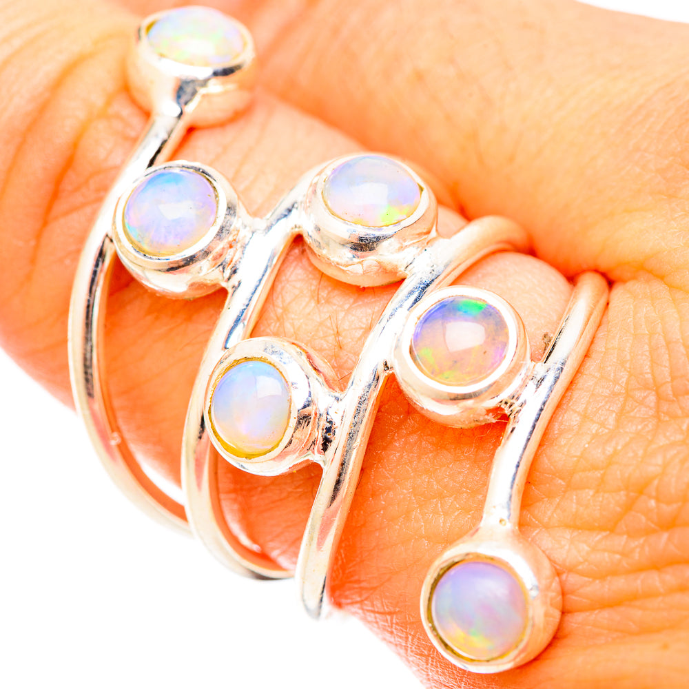 Sterling silver opal ring close-up on hand with five iridescent cabochons