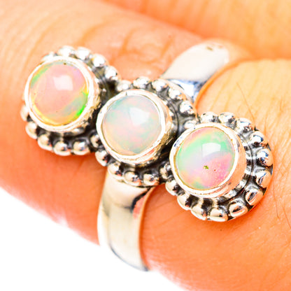 Sterling silver opal ring with three round iridescent opal cabochons