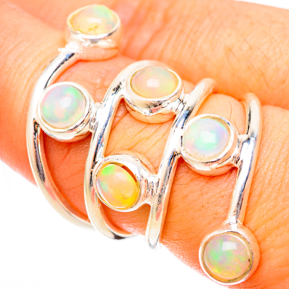 Sterling silver opal ring with six round cabochons in an open, curved band