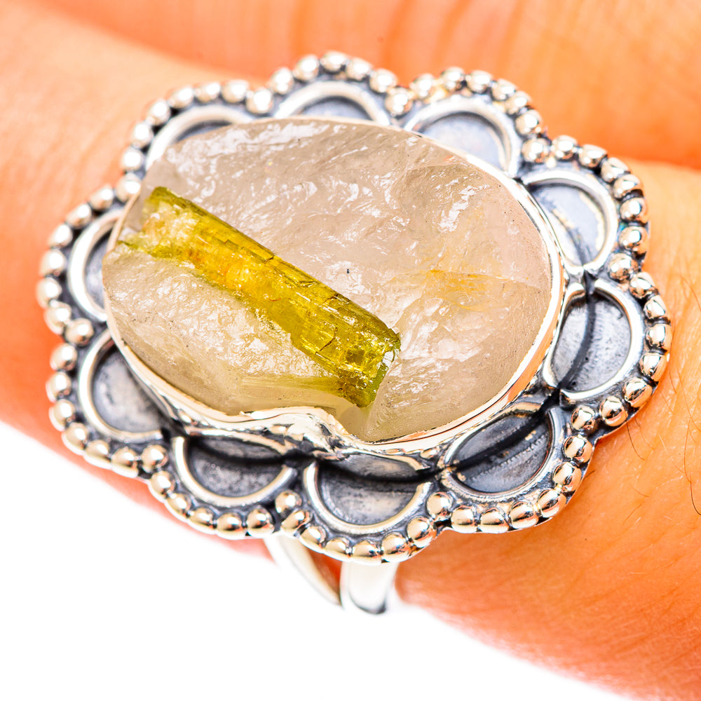 Oval tourmaline quartz ring in sterling silver, worn on finger with decorative blue bezel
