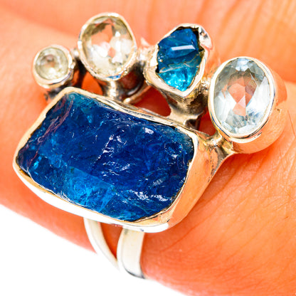 Sterling silver gemstone ring with large rough blue center stone and round clear side stones