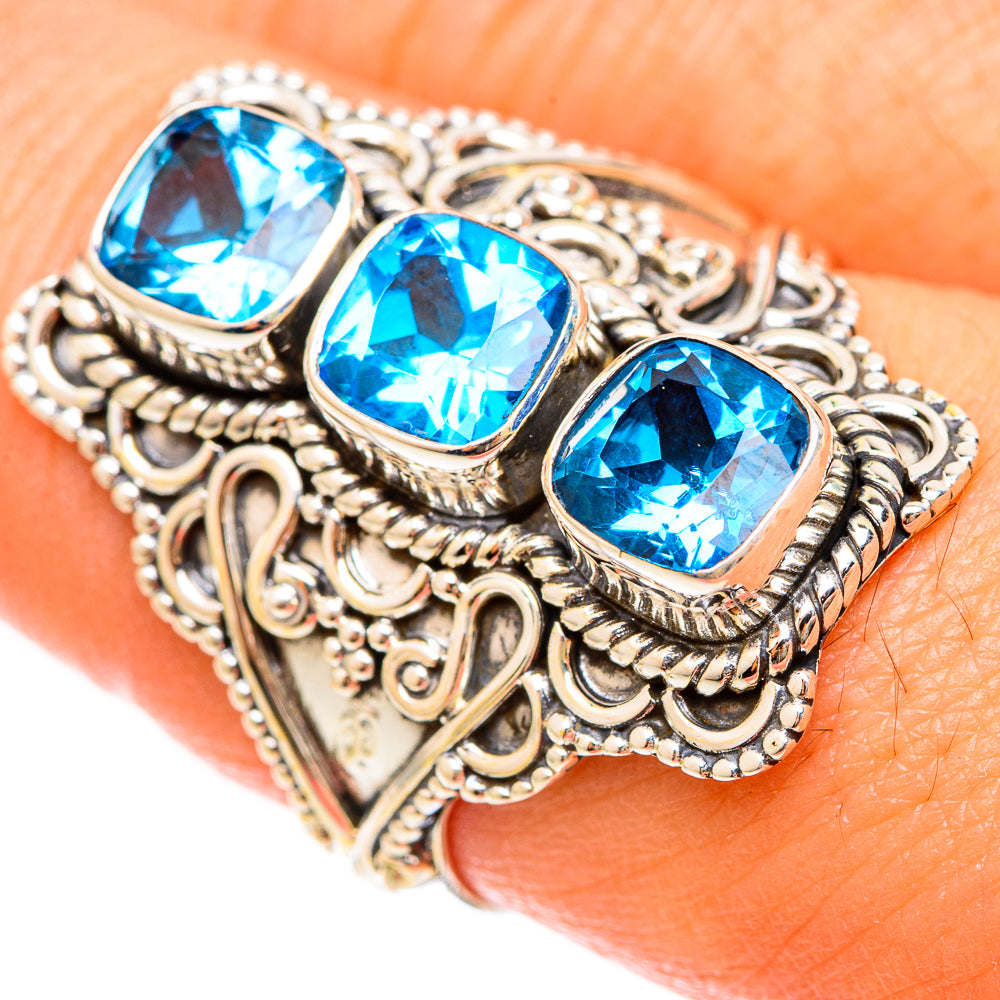 Sterling silver ring with three cushion-cut blue gemstones, ornate filigree setting