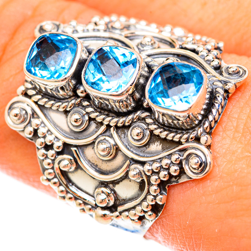 Close-up of sterling silver ring with three bright blue round stones and bead filigree