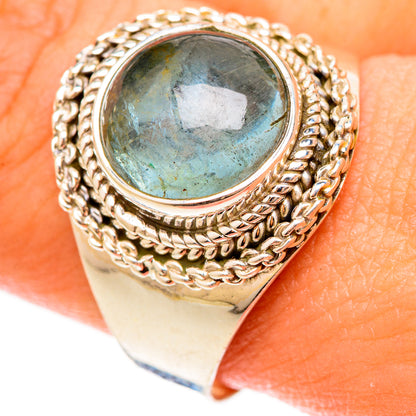Aquamarine oval cabochon ring with rope-and-bead frame on gold-tone band