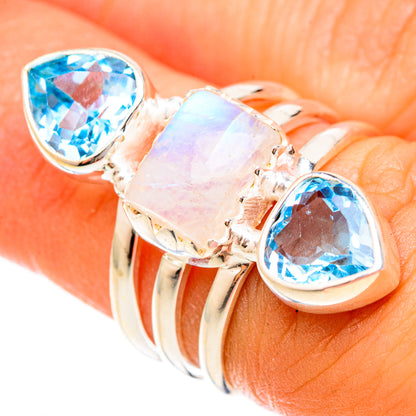 Sterling silver ring with oval blue topaz stones and a pale opal centerpiece