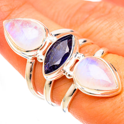 Silver ring with oval rainbow moonstone and faceted dark blue center stone, size 7