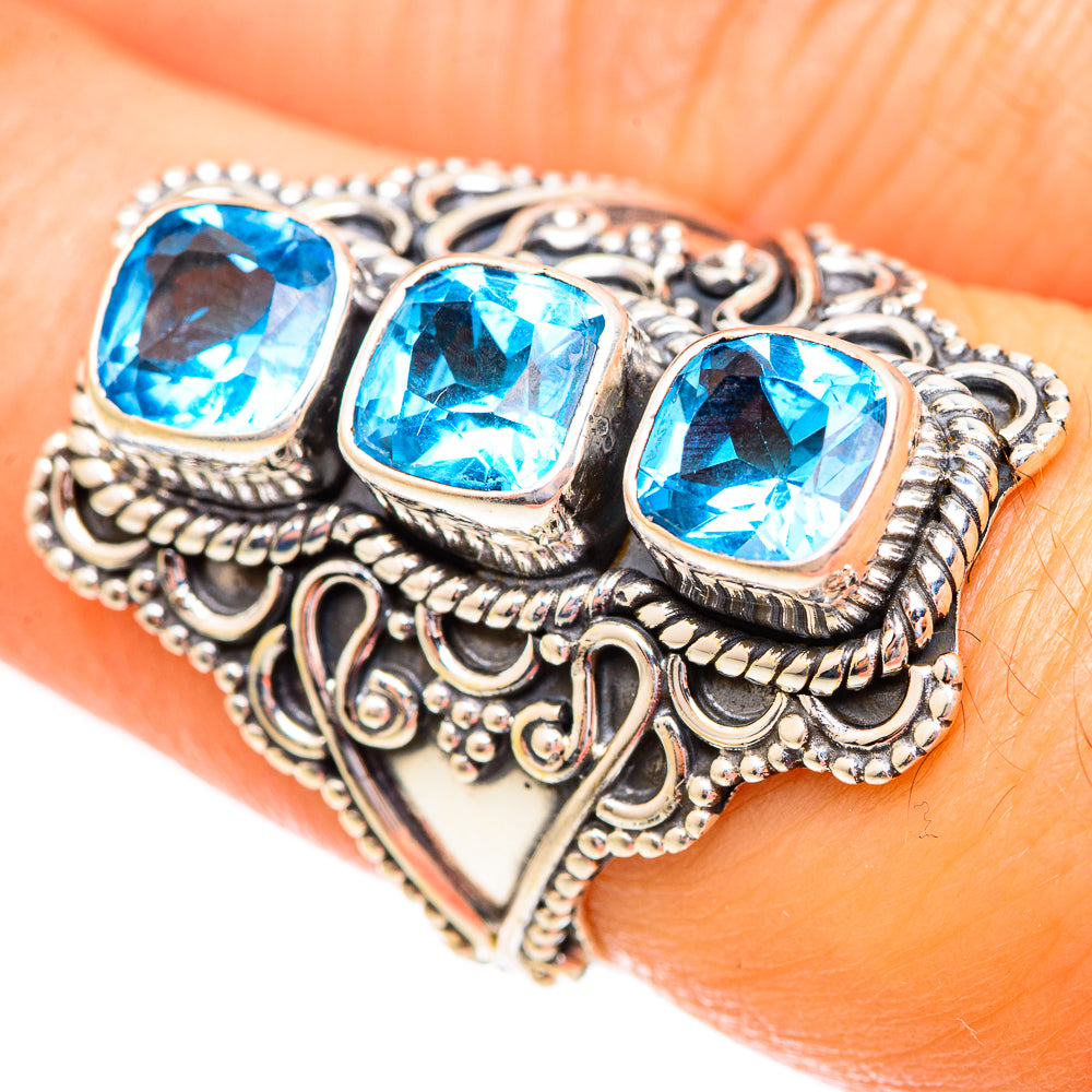 Sterling silver ring with three square blue topaz stones and scalloped filigree band