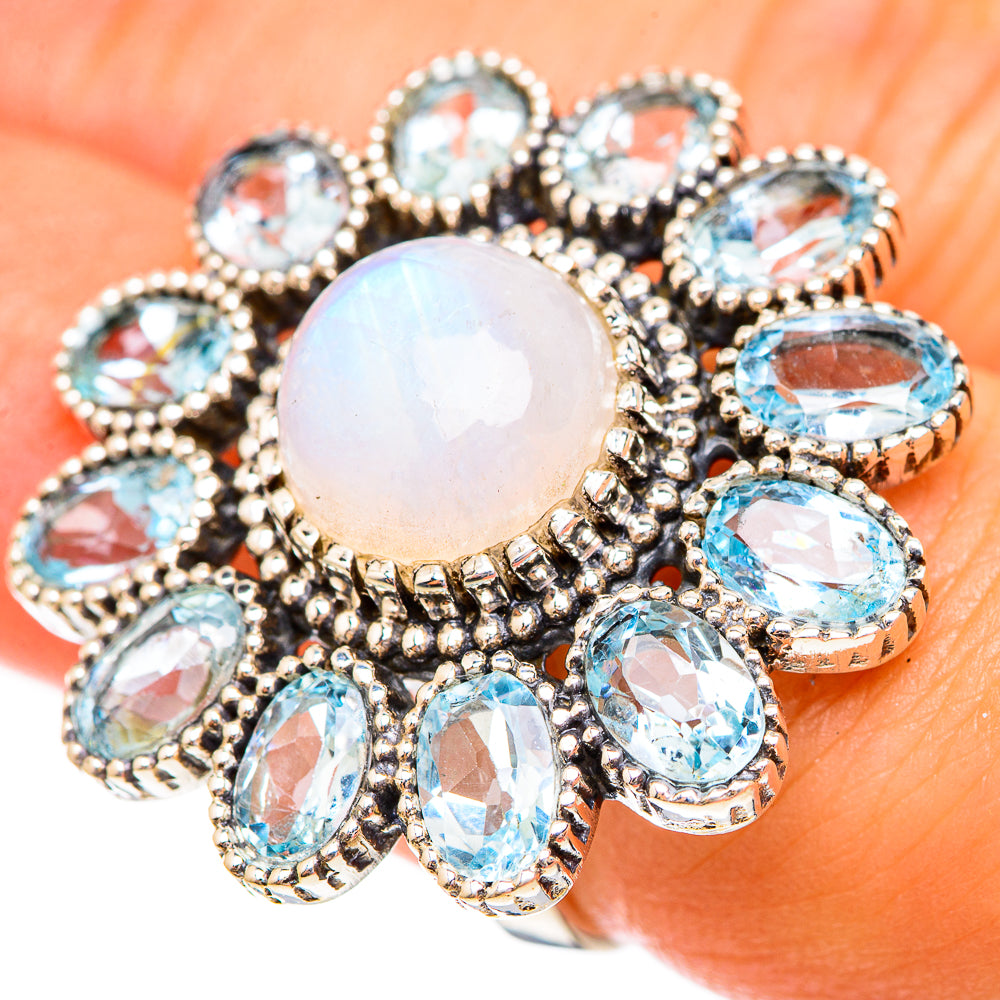 Opalescent center gemstone ring with multiple oval blue gemstones in arched cluster
