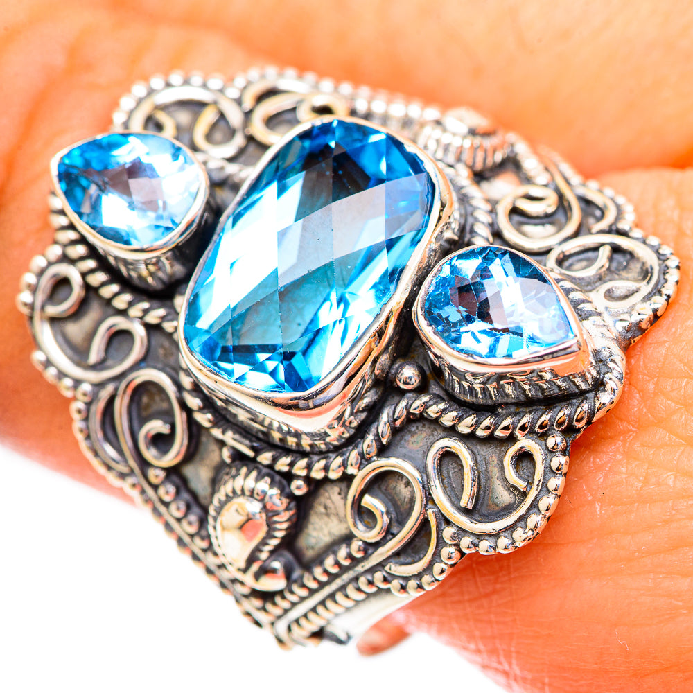 Sterling silver ring with faceted blue topaz oval center and two oval side stones