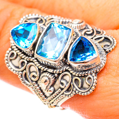 925 sterling silver ring with three faceted blue topaz stones and engraved scrollwork