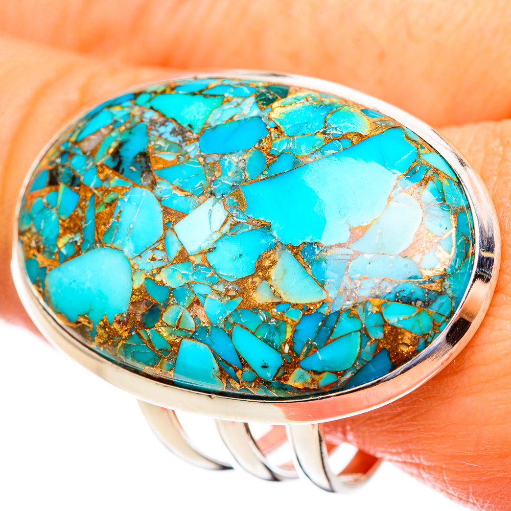 Oval turquoise cabochon ring with gold-toned copper web in silver bezel