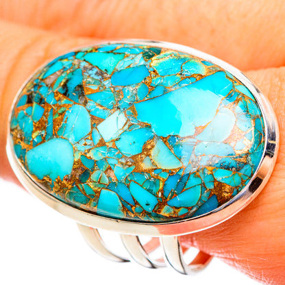 Oval turquoise cabochon ring with gold-toned copper web in silver bezel