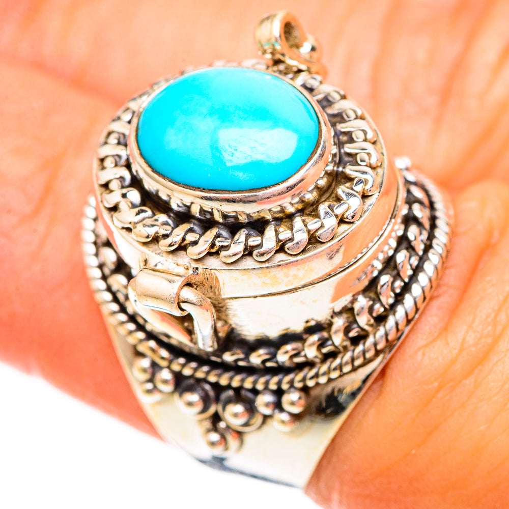 Silver ring with turquoise oval gemstone and scrollwork bezel, top view