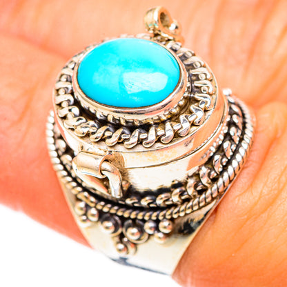 Silver ring with turquoise oval gemstone and scrollwork bezel, top view