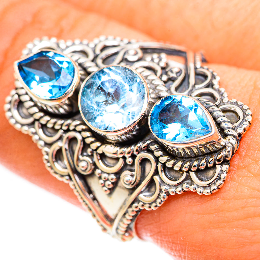 Sterling silver ring with three Swiss blue topaz stones and decorative scrollwork side band