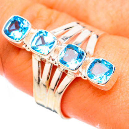 Sterling silver ring close-up with four blue oval gemstones on band