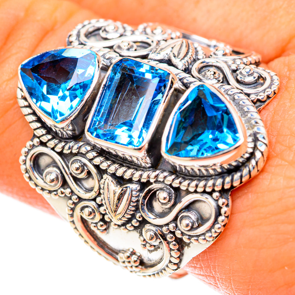 Silver statement ring with three large blue cut stones and engraved scrollwork bezel