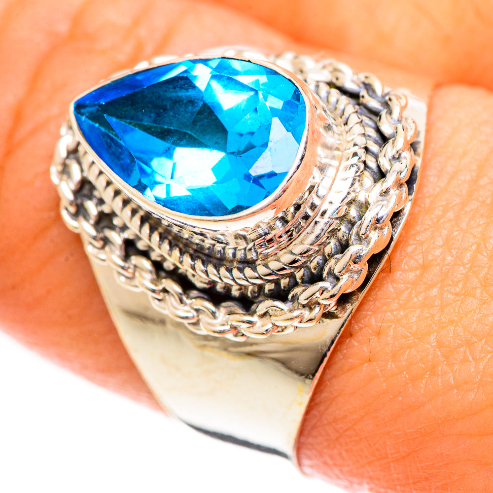 Sterling silver ring with large oval blue gemstone, braided prongwork setting