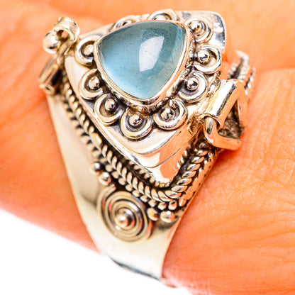 Sterling silver ring with oval aquamarine-style gemstone and ornate scrolling band