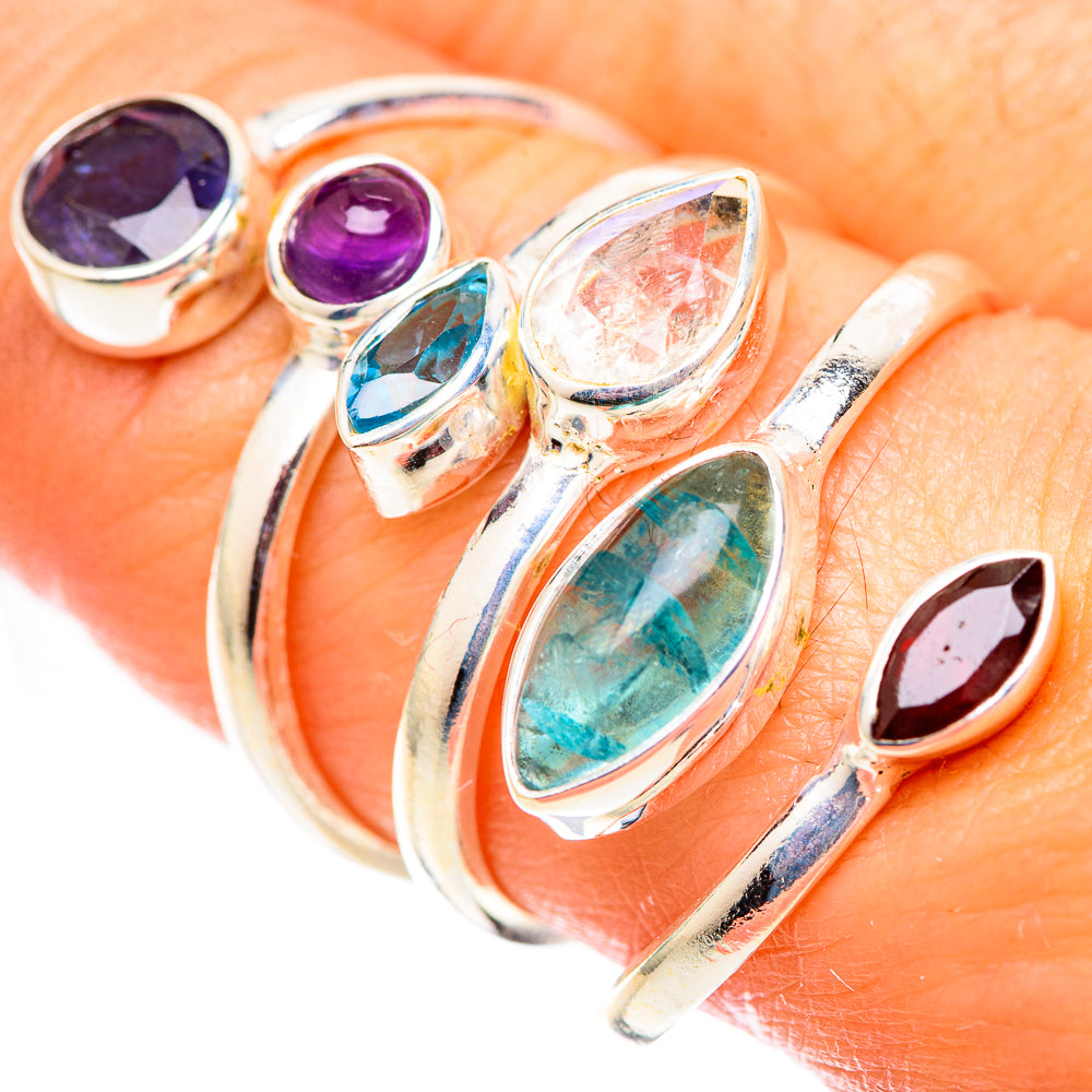 Silver multi-stone ring close-up with purple, teal, clear, green and maroon gemstones