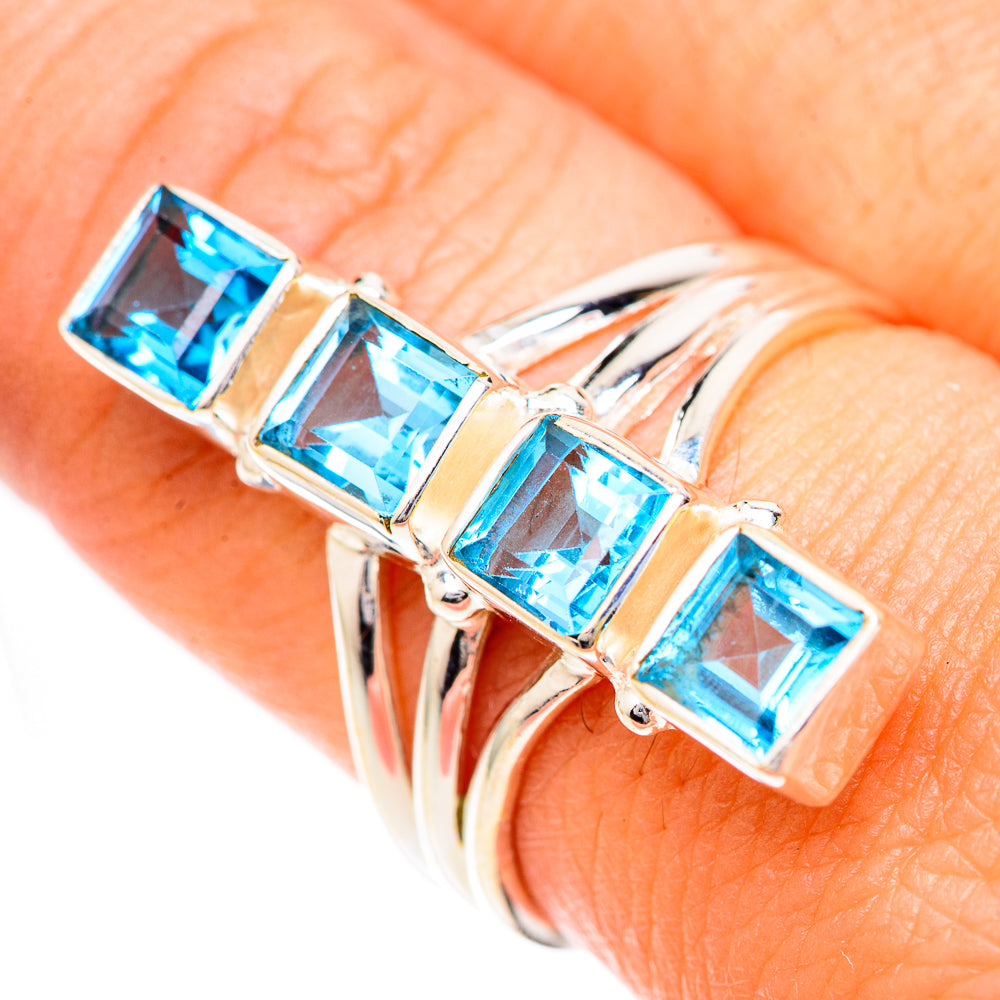 925 sterling silver ring featuring four square blue topaz stones in a row