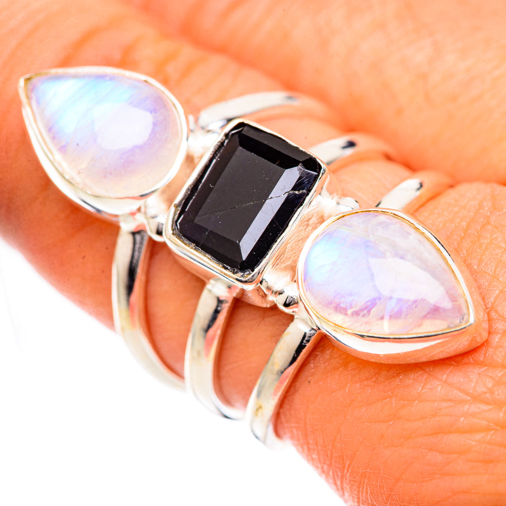 Sterling silver ring on hand, with black-blue square stone and two iridescent oval gems