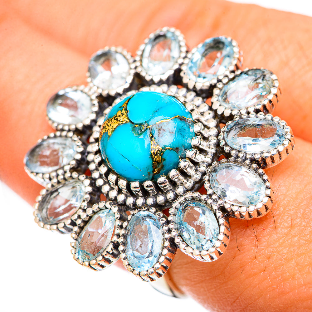 Turquoise center oval ring surrounded by oval blue and clear stones, silver prong setting