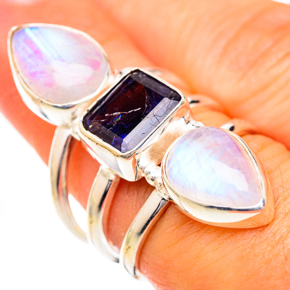Sterling silver ring with oval opal-like stones and dark purple faceted center gem